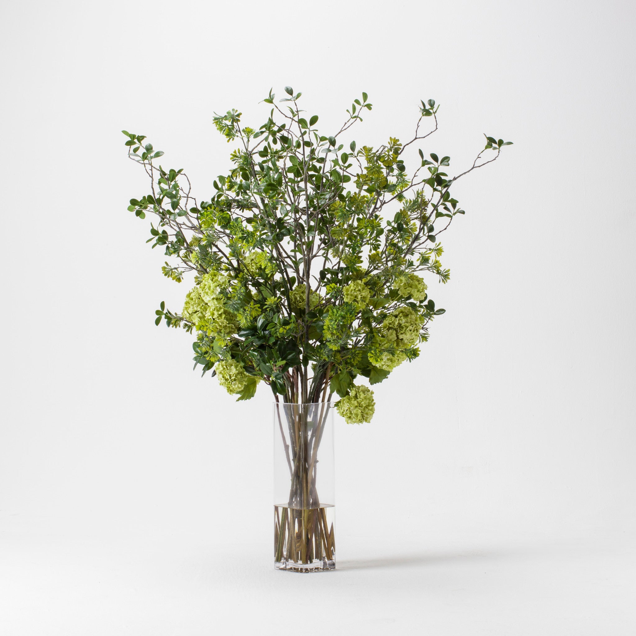 Mixed Greenery In Tall Glass Square Vase